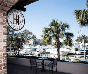 table and chairs overlooking marina of boats at Hilton Head Social Bakery