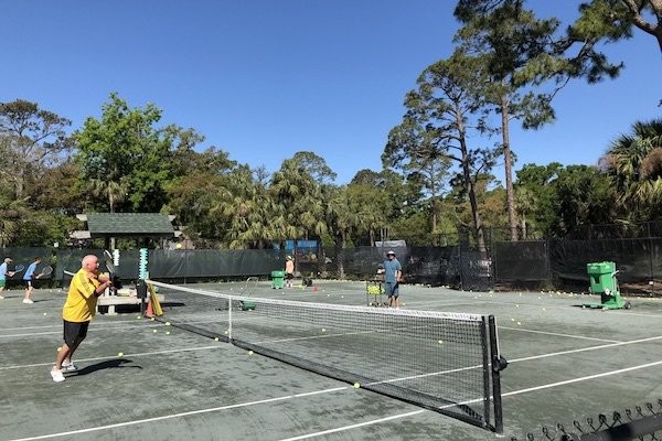 tennis players practicing tennis drills during lessons