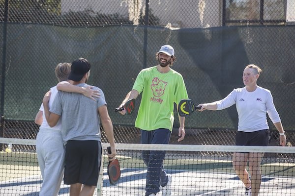 Pickleball players congratulating each other at the end of a game