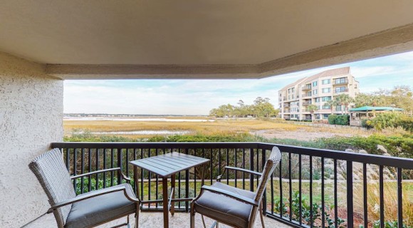 patio furniture on a private balcony of a Hilton Head vacation rental overlooking the marsh
