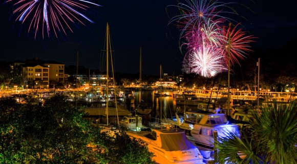 Fireworks above a marina in the evening