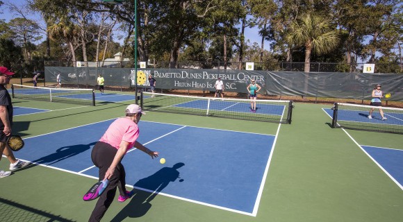 action shot of pickleball players on several palmetto dunes pickleball courts
